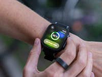 A close-up of an Apple Watch displaying a battery level of 86% and a low power mode notification.