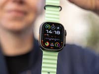 The Ultra 3 shown at an angle highlights its rugged titanium frame, flat sapphire crystal surface, and textured side profile. A close-up of an Apple Watch 3 Ultra on a green strap, displaying the time 14:18 and various fitness metrics.