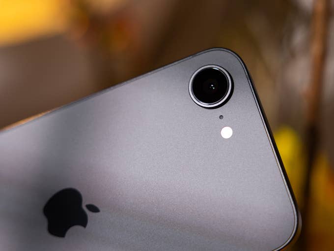Close-up of an Apple iPhone 16e camera with a silver finish and the Apple logo.