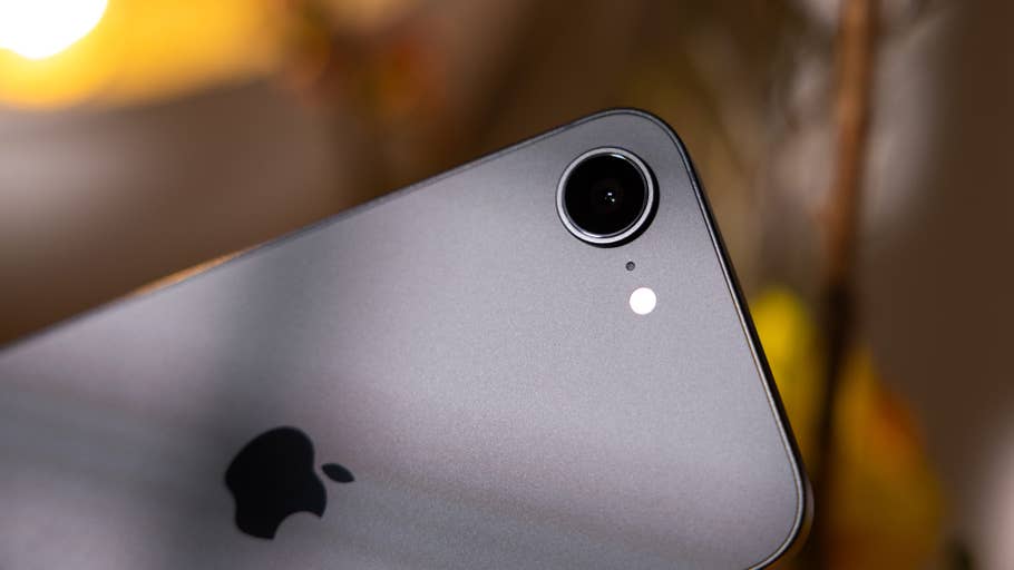 Close-up of an Apple iPhone 16e camera with a silver finish and the Apple logo.