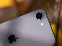 Close-up of an Apple iPhone 16e camera with a silver finish and the Apple logo.