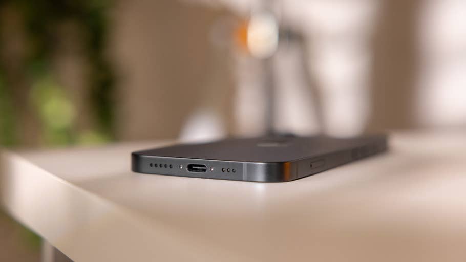 Close-up of the bottom of an Apple iPhone 16e showing the charging port and speaker grille.