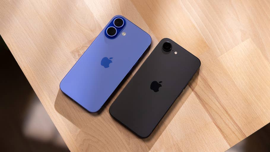 Two iPhones on a wooden surface: a blue iPhone 16 and a black iPhone 16e.