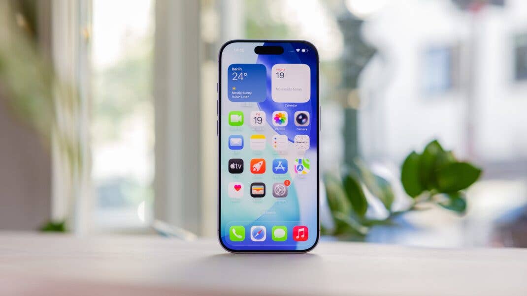 An iPhone 17 displays a colorful home screen with various app icons and a weather widget.