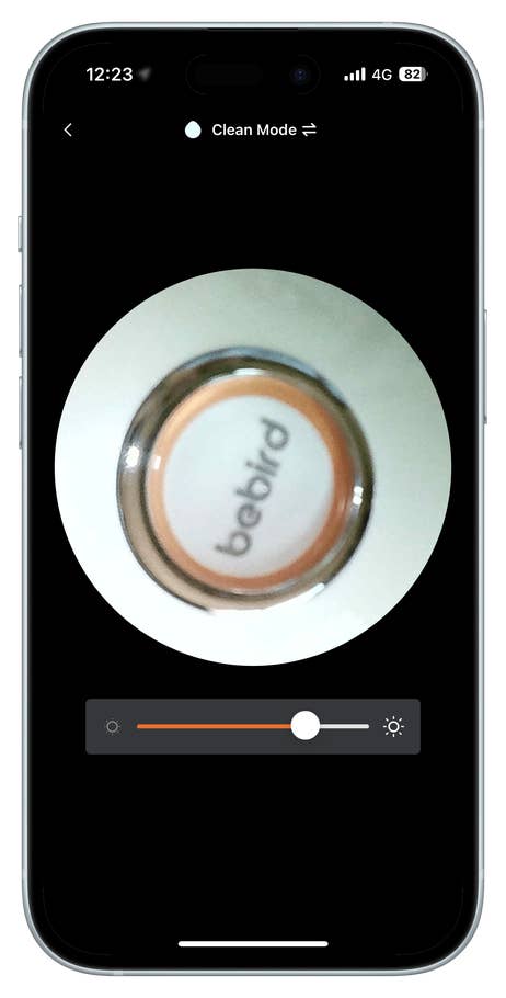 Close-up of a Bebird device with a control slider and a clean mode indicator on a smartphone screen.