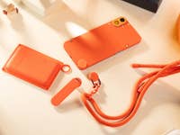 CMF Phone 1 with its launch accessories: lanyard, stand, and cardholder.