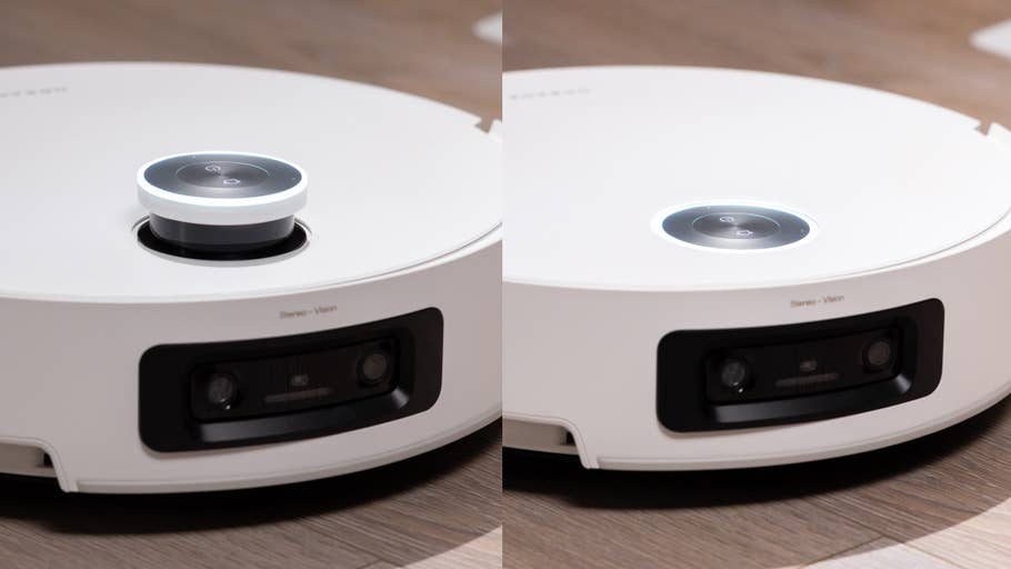 A white, round robot vacuum cleaner with a central sensor on a wooden floor.