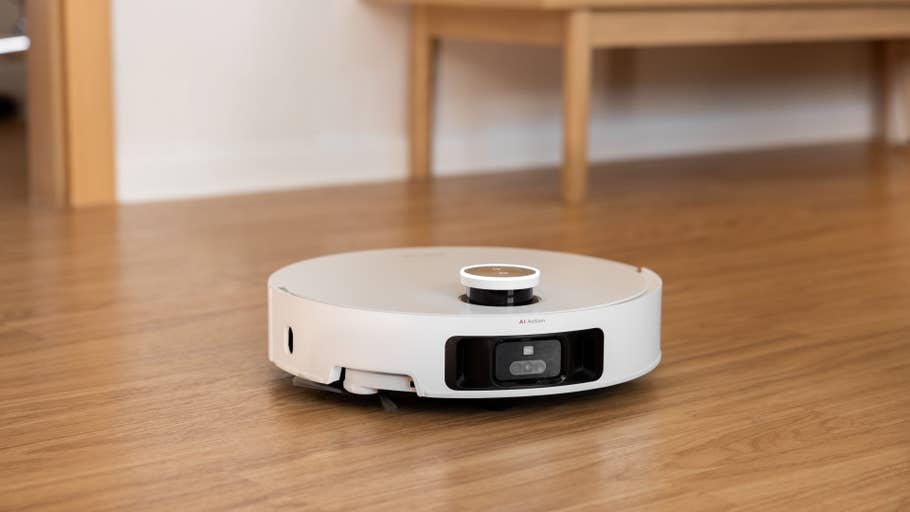 A Dreame X50 Ultra robot vacuum cleaner on a wooden floor.