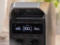 The Ecoflow Delta 3 Plus has a futuristic, funky look and comes with a larger LCD screen. EcoFlow Delta 3 Plus portable power station with display showing 100% battery and various output/input details.