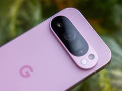 Close-up of a Google Pixel 9 Pro smartphone in a soft pink color, highlighting the camera module.