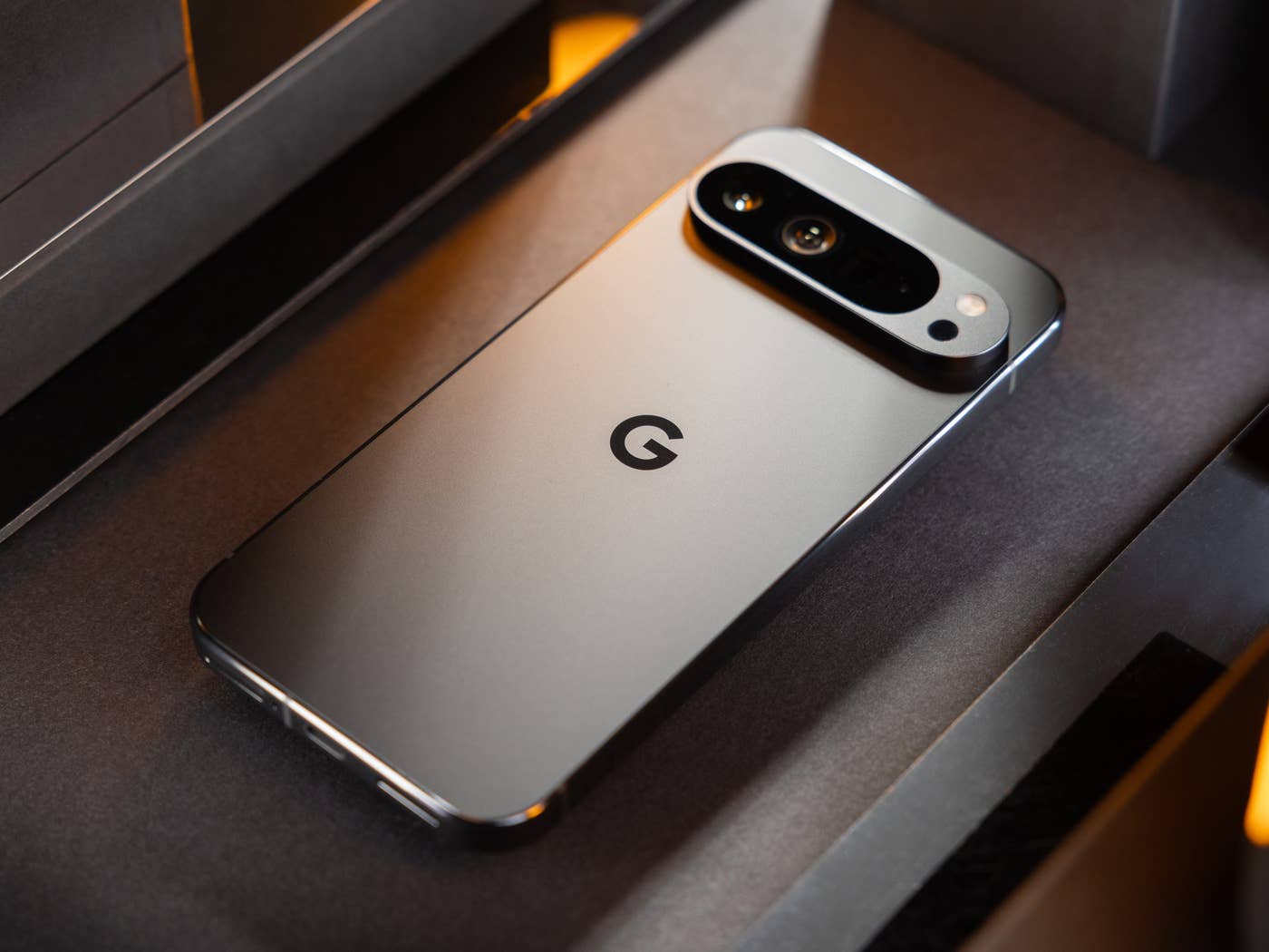 The Google Pixel 9 Pro seen at an angle and placed face down on a table.