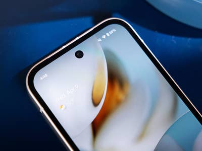 Close-up of a Google Pixel 9a smartphone showing the home screen with the date and weather.