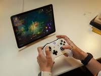 A person is playing a game on the Google Pixel Tablet using a connected Xbox controller.