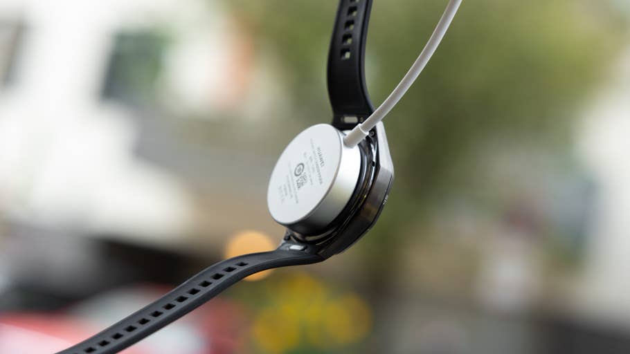 Huawei Watch GT 6 Pro with charging cable attached, displaying the back of the watch.