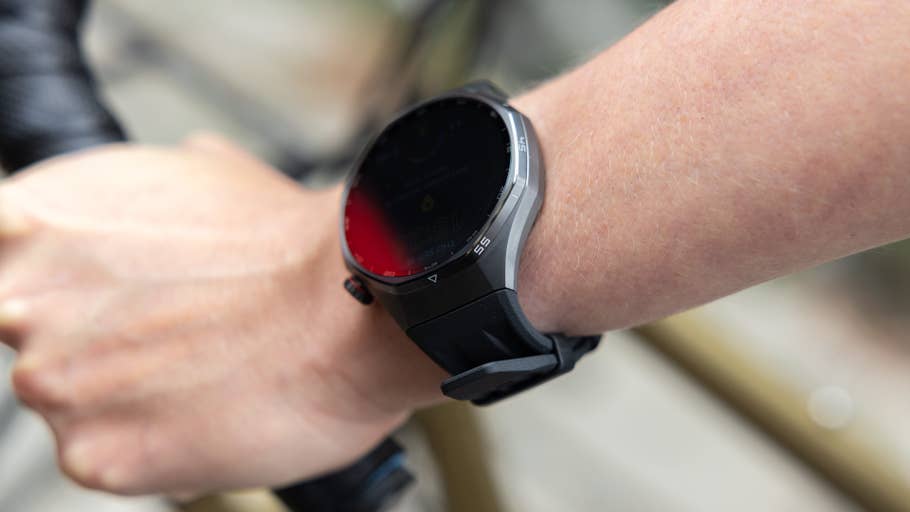 A close-up of a Huawei Watch GT 6 Pro on a personu0027s wrist, gripping a bicycle handlebar.