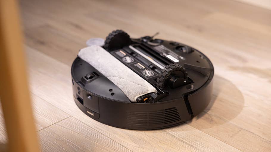 A Mova Z50 Ultra robotic vacuum cleaner on a wooden floor.