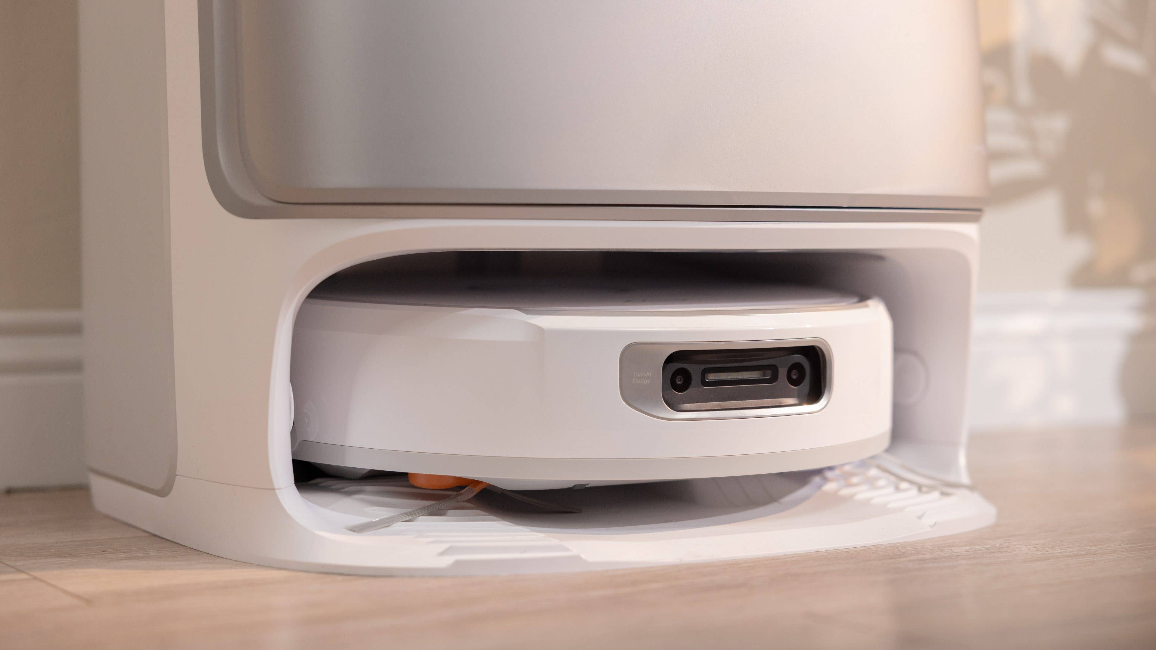 A robotic vacuum cleaner docked in a charging station.