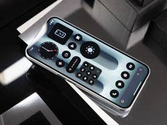 A Nothing Phone 2A Plus displaying a sleek interface with various app icons on a reflective surface.