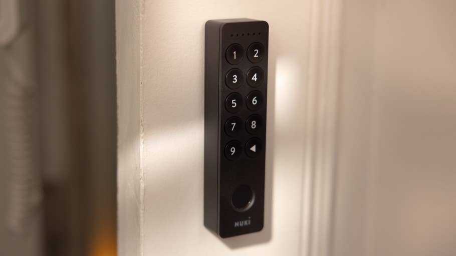 A Nuki Smart Lock Pro mounted on a wall with a numeric keypad.
