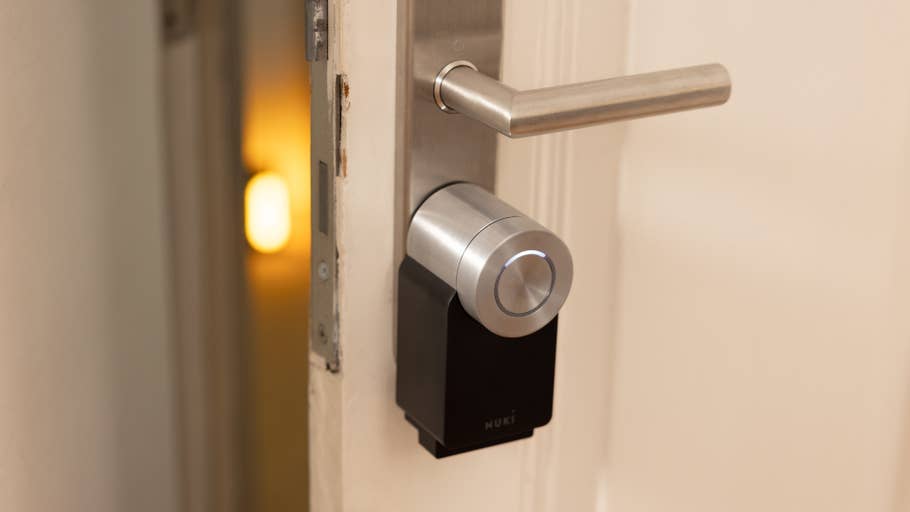 Close-up of a Nuki Smart Lock Pro installed on a door handle.