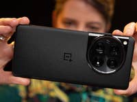 A person holding the OnePlus 12 highlighting the camera module