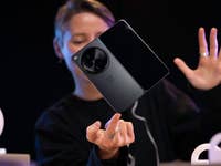 a person balancing the OnePlus One on one finger