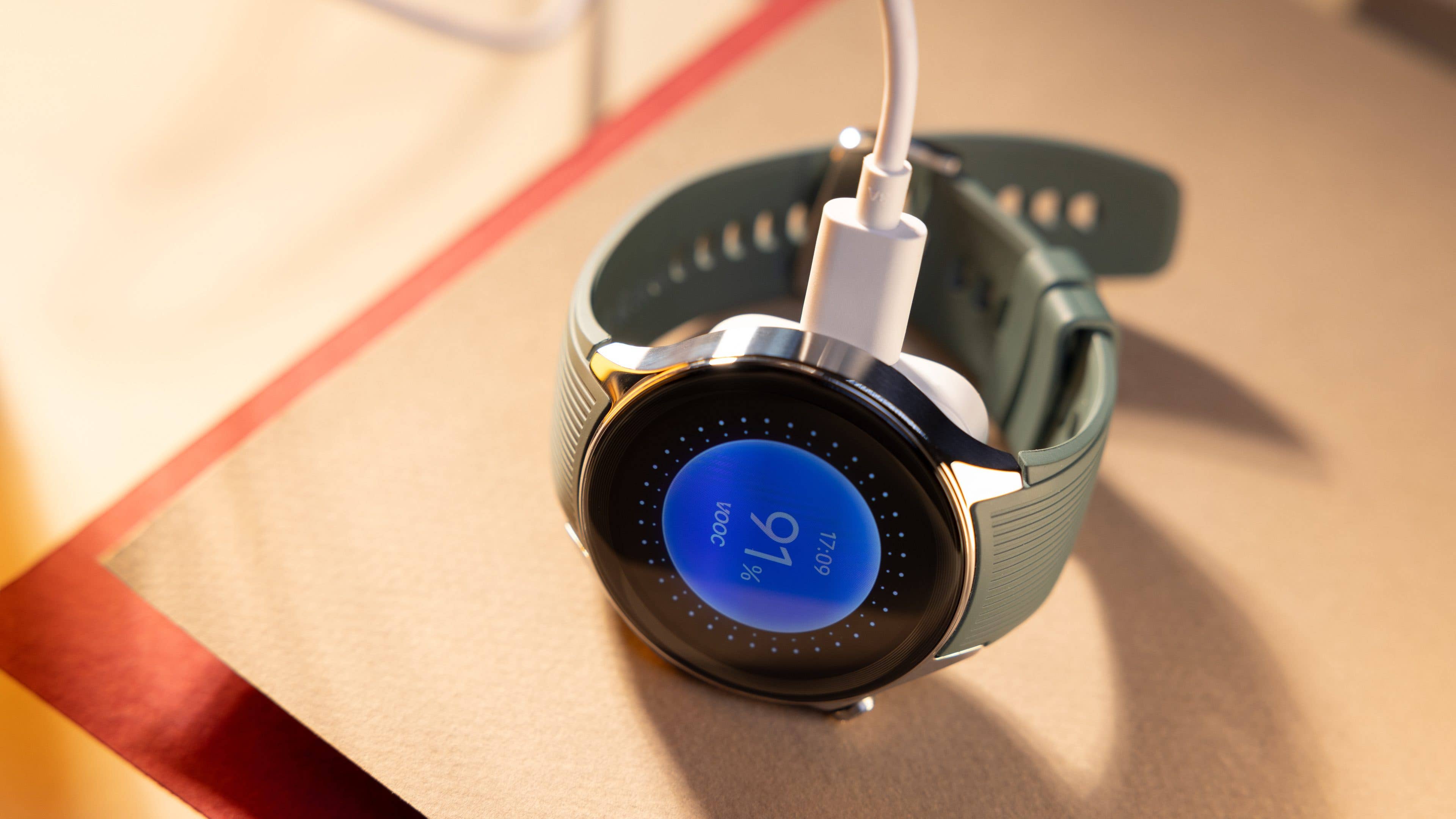 OnePlus Watch 2 charging with the Super Vooc logo in detail.