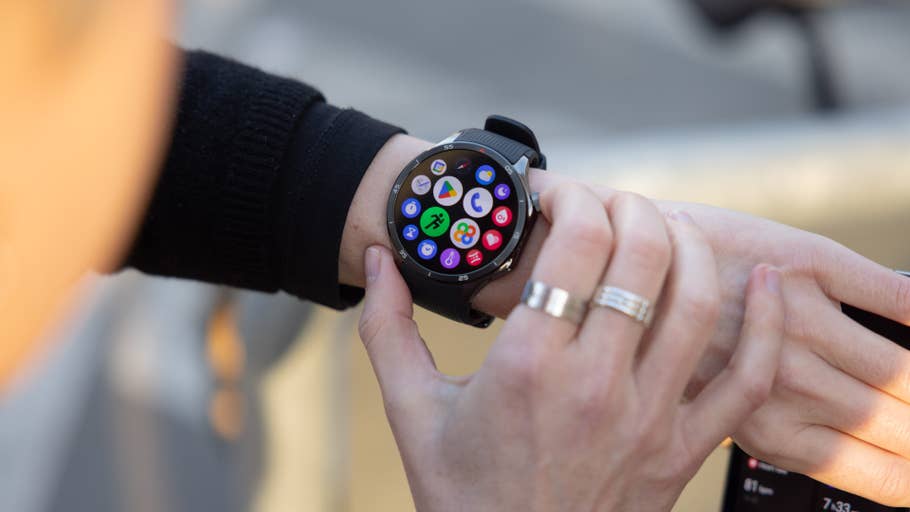 A person interacting with a OnePlus Watch 3 displaying various app icons on the screen.