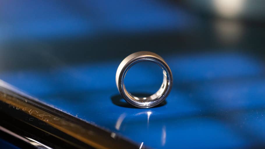 A close-up of the Oura Ring 4 resting on a reflective surface.