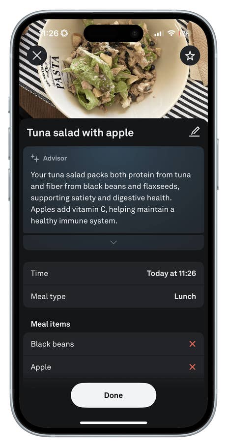 A phone screen displaying a tuna salad with apple, meal details, and nutritional advice.