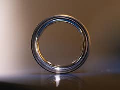 A close-up of an Oura Ring, showcasing its sleek design and shiny surface.
