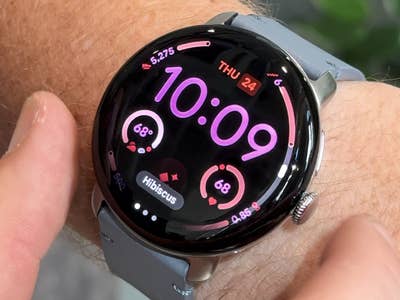 A Google Pixel Watch 4 displaying the time 10:09 and fitness stats on a wrist.
