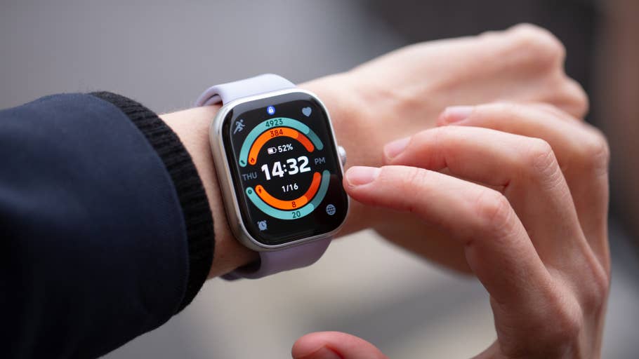 A close-up of a Redmi Watch 5 displaying time, date, and fitness data on a wrist.