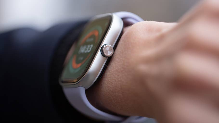 Close-up of a Redmi Watch 5 on a wrist displaying time and fitness metrics.