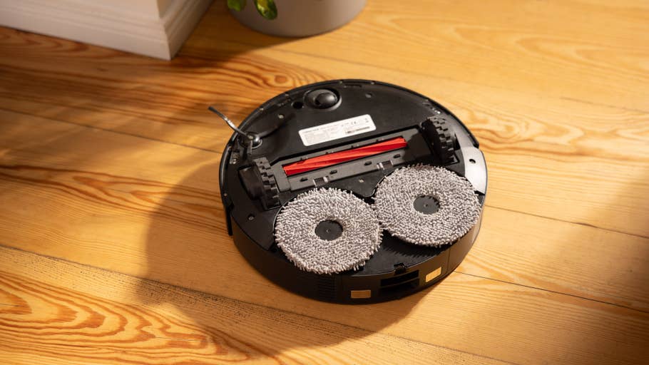 Roborock Qrevo S upside down, showing its mopping pads