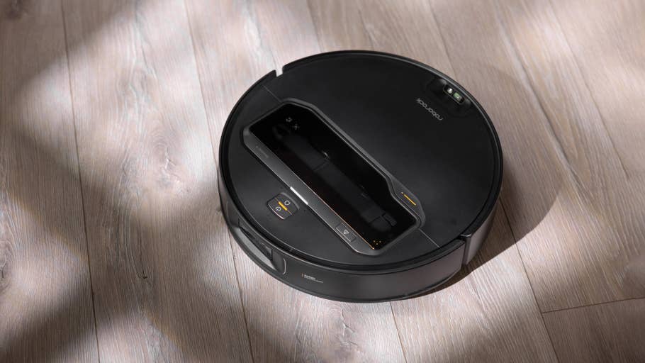 A Roborock Saros Z70 robot vacuum cleaner on a wooden floor.