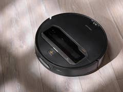 A Roborock Saros Z70 robotic vacuum cleaner on a wooden floor.
