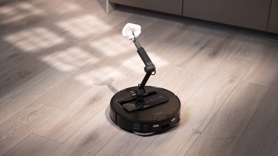 A Roborock Saros Z70 with mop attachment on a wooden floor.