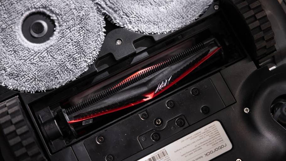 Close-up of the Roborock Saros Z70u0027s interior with a red brush and microfiber cloths.