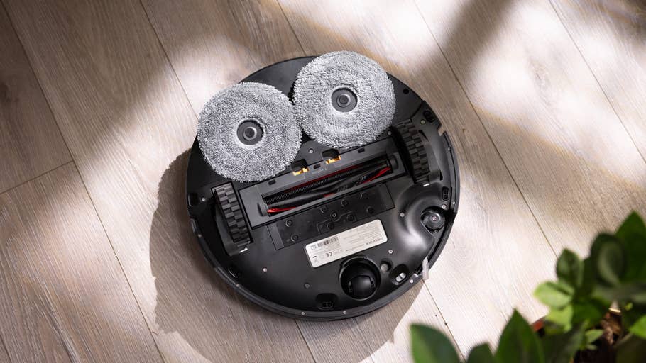 Roborock Saros Z70 robot vacuum cleaner as seen from above on a wooden floor.