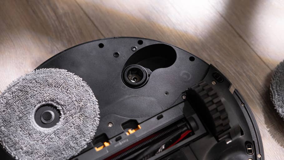 Close-up of the underside of a Roborock Saros Z70 robot vacuum cleaner with cleaning pads.