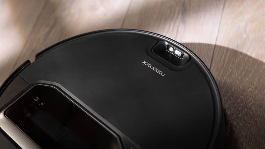 Roborock Saros Z70 robot vacuum cleaner on wooden floor.