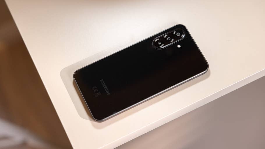 A Samsung Galaxy A26 smartphone lying on a white table.