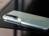 A Samsung Galaxy A56 smartphone lying on a reflective black surface.