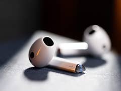 Two Samsung Galaxy Buds 3 wireless earbuds resting on a dark surface.