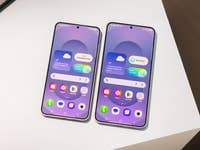 Two Samsung Galaxy S25 smartphones displaying a user interface with weather and app icons.