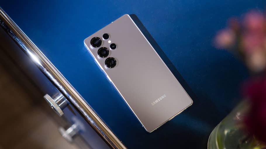 Samsung Galaxy S25 Ultra smartphone on a blue surface.