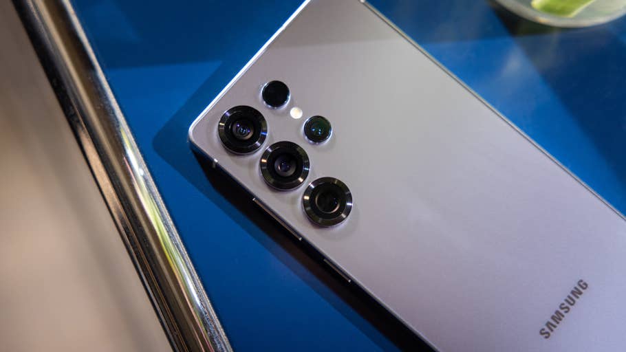 Samsung Galaxy S25 Ultra smartphone with multiple camera lenses on a blue surface.