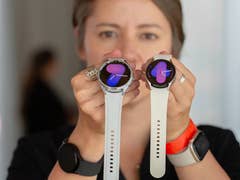 A person holding the Samsung Galaxy Watch 6 and Watch 6 Classic side by side