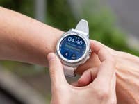 A person using a Samsung Galaxy Watch 8 Classic on their wrist, displaying time and fitness stats.